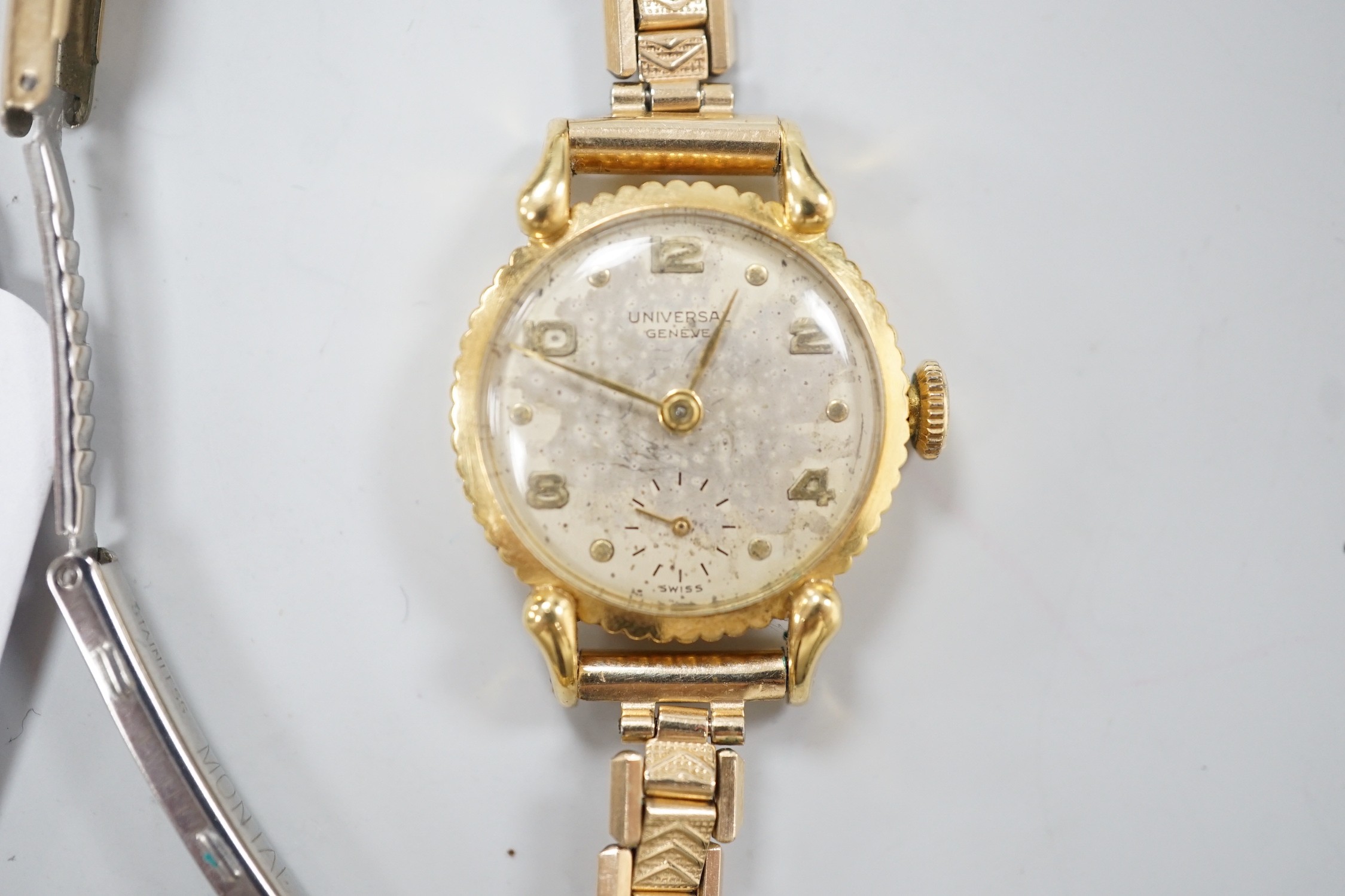 A lady's 750 yellow metal Universal manual wind wrist watch, on associated gold plated bracelet.